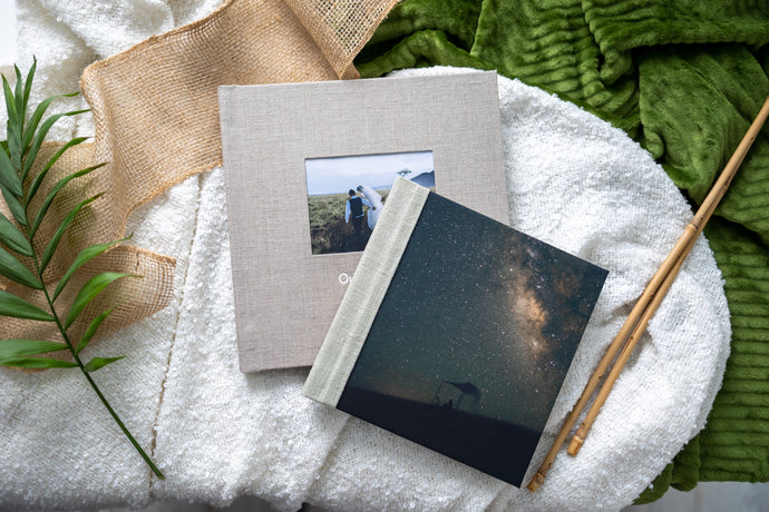 Hahnemuhle Baryta Bamboo fine art album from QTALBUMS with choice of personalizations. Pictured: linen cover with cameo and standard embossing (bottom), and our soft-touch Photo Panel cover style (top).